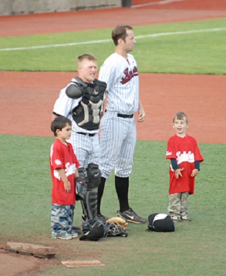 Red Robin baseball buddies await the National Anthem with Knights' pitcher Chris Johnson and catcher Dane Lund