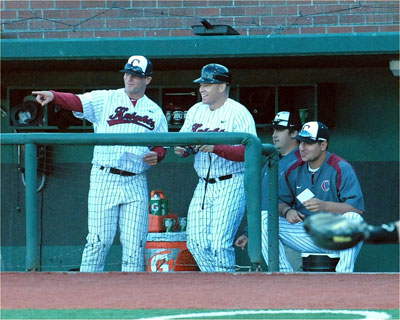 Assistant coach Andy Jenkins, head coach Brooke Knight, trainer Jeremy Ainsworth and pitching coach Connor Lambert share a laugh in the dugout